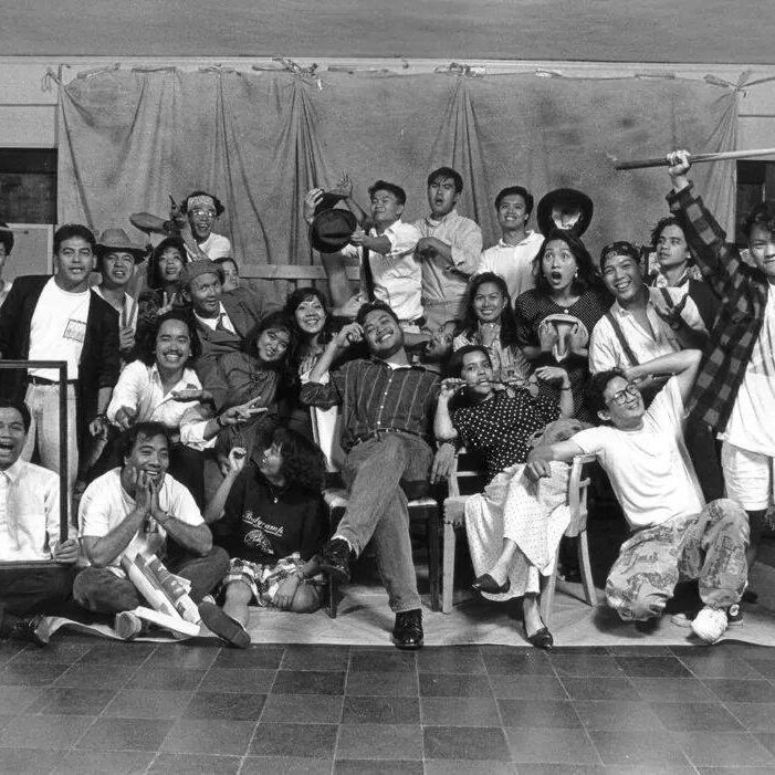 Black-and-white group photo of the CIRCA Pintig cast and crew posing together, laughing and celebrating backstage.